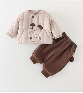 Detail of baby quilted jacket with dog embroidery and matching brown trousers
