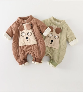 Close-up of quilted baby romper featuring cute cartoon puppy patches and dual zip design