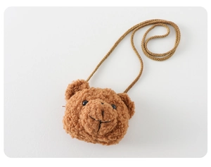 Detailed view of soft brown plush bear bag accessory for baby quilted romper