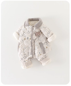 Detailed close-up of quilted baby romper with bear prints and corduroy trim accents