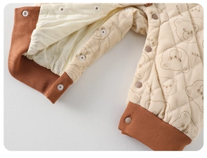 Detail of baby quilted cotton romper showing cute bear print and soft ribbed cuffs