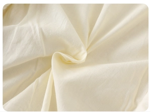 Close-up of soft beige organic cotton fabric with natural texture for baby rompers