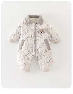 Detail of baby quilted romper with forest bear prints and corduroy trim accents