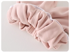 Detail of pink fleece baby pants showing the thick lining and elastic waistband