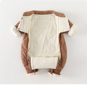 Close-up of brown quilted baby romper with front zipper and windproof ribbed cuffs