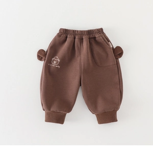 Detail view of toddler thick fleece pants with cute 3D ears and brown bear print