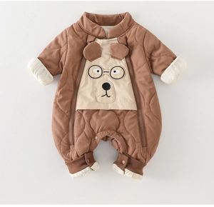 Close-up of quilted baby romper with bear embroidery and functional double zipper