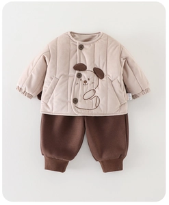 Detailed close-up of quilted winter jacket with cartoon dog and brown jogger pants