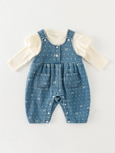 Cute two-piece baby girl outfit with cream ribbed top and blue polka dot overalls