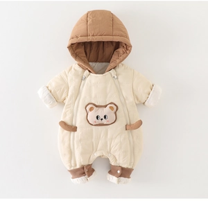 Close-up of quilted beige infant romper with dual zippers and cute bear patch embroidery