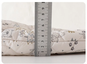 Detail view of the 5.5cm thick thermal quilted fabric for baby winter jumpsuit