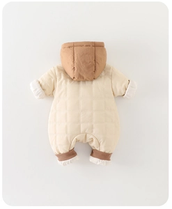 Detail of baby winter jumpsuit featuring quilted grid fabric and brown ribbed cuffs