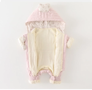 Detail of baby quilted romper showing pink snap buttons and floral pattern hood lining