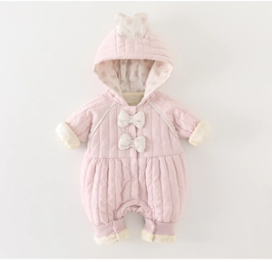 Detail of pink quilted baby romper featuring floral bow accents and warm hooded design