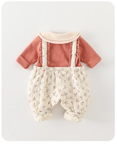 Detailed close-up of quilted floral overalls with ruffle straps and bean paste red collar top
