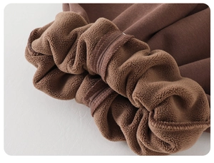 Detail of warm lamb wool lining and elastic cuffs on brown thermal baby winter pants