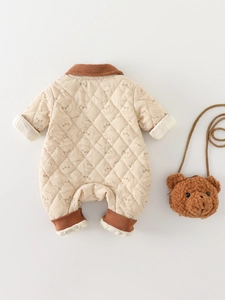 Quilted beige baby romper with bear print, ribbed collar, and plush bear bag accessory