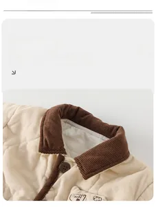 Detailed view of beige corduroy jacket with brown collar and small plane embroidery
