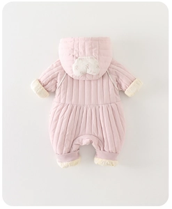 Close-up of quilted pink baby romper with floral hood detail and yellow fleece lining