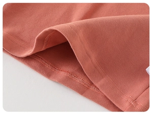 Detailed close-up showing precision double-needle stitching on cotton floral baby romper