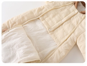 Detailed macro view of quilting, durable zipper, and snap buttons on baby quilted romper