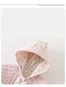 Detail of pink quilted baby romper featuring floral lining and heart hooded decoration