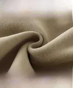 Detail shot of high-density khaki knit fabric showing soft texture and premium warmth