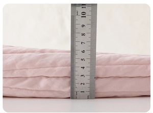 Close-up of pink quilted baby romper showing a thick 5.5cm warm padded cotton layer