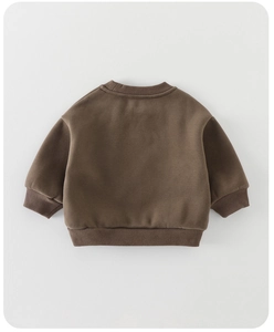 Detail of dark brown toddler fleece sweatshirt featuring ribbed cuffs and warm crewneck design