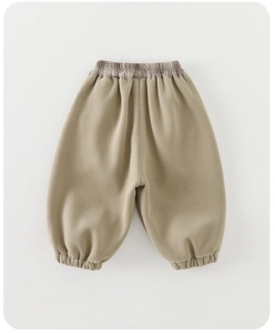 Close-up of khaki thickened velvet pants with elastic waistband and brown plaid lining