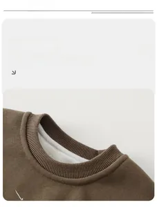Close-up of brown kid sweatshirt with warm white fleece lining and ribbed neckline