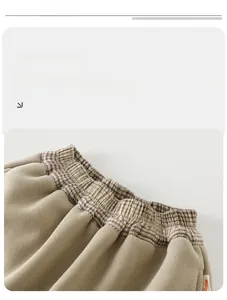 Detail of checkered elastic waistband and soft fabric on warm toddler winter pants