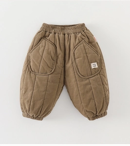 Close-up of quilted toddler pants featuring thick fleece lining and elastic cuffs in brown