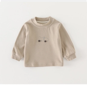 Close-up of baby ribbed long-sleeve tee with minimalist car embroidery and button wheels