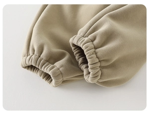Close-up of elastic ribbed cuffs on warm beige fleece-lined trousers for girls