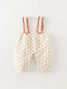 Quilted floral baby romper with cherry red ruffled straps and warm autumn floral print