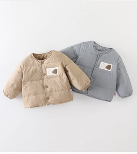 Detail of baby winter down jackets featuring round neck and resin buttons on quilted fabric