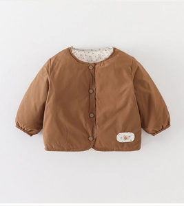 Detailed view of kids' brown down jacket with floral lining and secure button closure