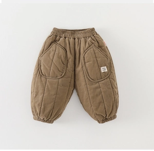 Detail view of toddler quilted pants showing elastic waist and large curved pockets