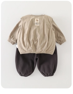 Detail view of toddler three-piece set featuring warm khaki vest and brown lantern pants