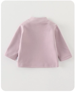 Detail view of pink baby long sleeve thermal shirt with soft knit texture and stitching