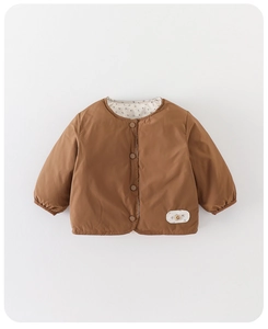 Close-up of brown kids' down jacket featuring floral lining and snap button details