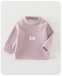 Detail of baby thermal long sleeve top with embroidered winter patterns on purple fleece