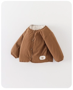 Detailed view of kids puffer jacket featuring warm inner lining and brown quilted fabric