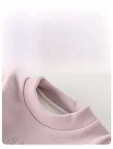 Macro view of pink long-sleeve thermal shirt with mock neck and soft fleece lining