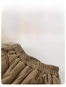 Detail of elastic waistband and neat stitching on brown corduroy infant trousers