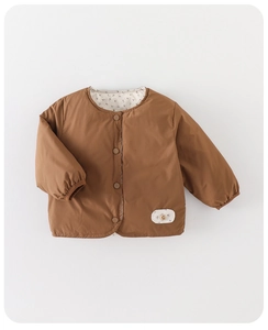 Detail view of child's warm brown down jacket with floral lining and elastic cuffs
