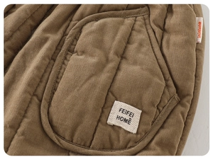 Detail of brown quilted corduroy fabric with diamond stitching and high-quality pocket
