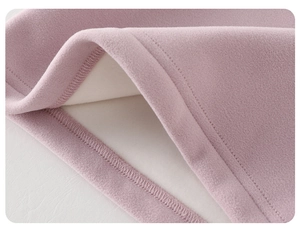 Detailed close-up of pink thermal baby shirt with soft fleece lining and fine stitching