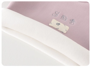 Detail of baby thermal top with thick fleece lining and cute winter embroidery art